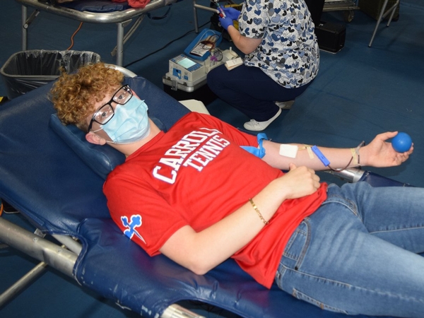 Ryan Ballou '21 donates blood at the Community Blood Center Blood Drive at Carroll High School.