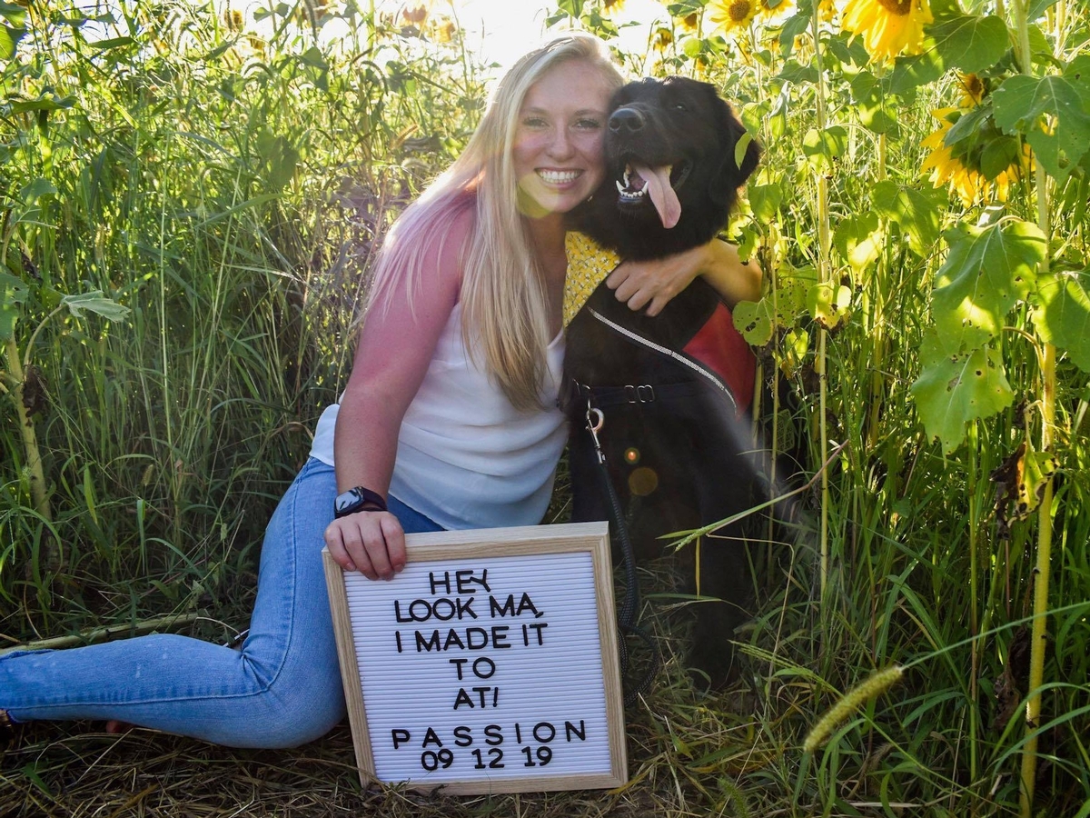 Morgan King '17 and her foster dog, Passion.  Morgan participates in 4 Paws for Ability's service dog foster college program through the University of Cincinnati.