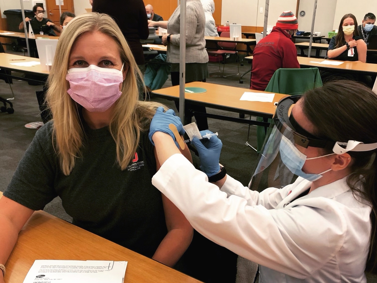 Lisa (Wahlrab) Walsh '05 receives the Pfizer-BioNTech COVID-19 vaccine at The Ohio State University Wexner Medical Center