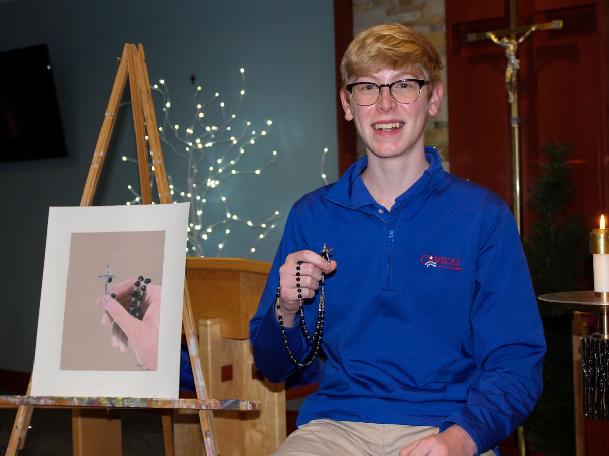 Carroll High School student Sam Wittmann '22 holds the rosary he received as a First Communion gift