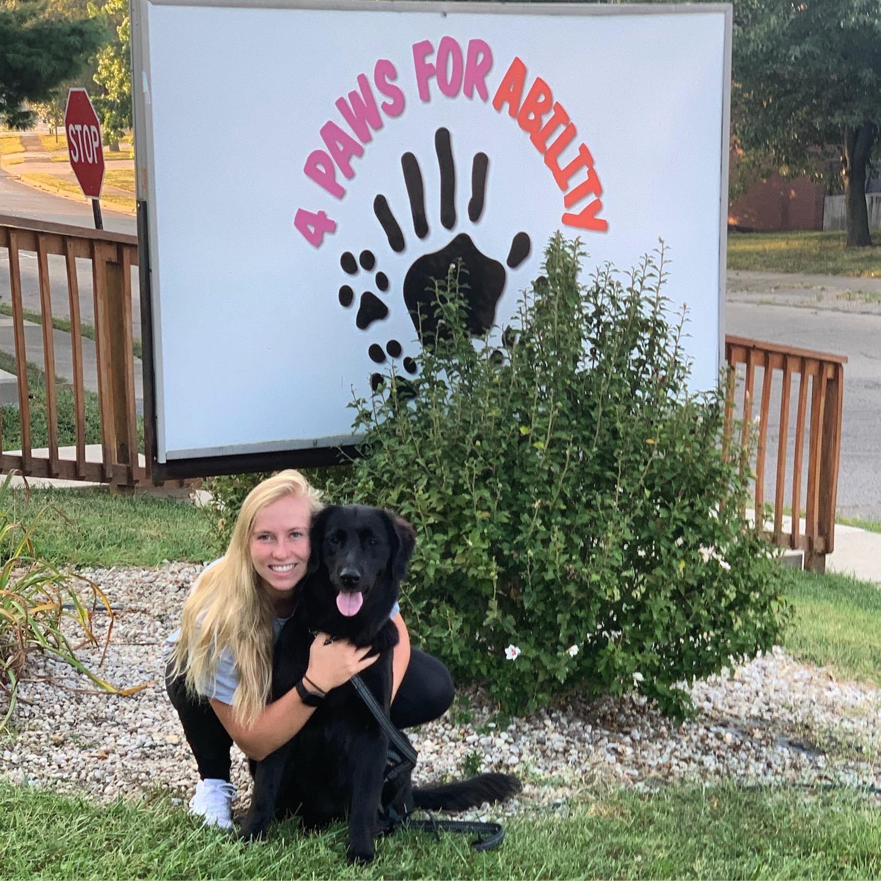 Morgan King '17 and a foster dog from 4 Paws for Ability.